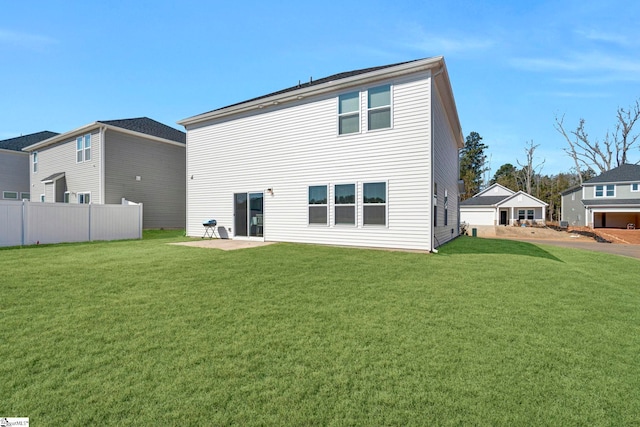 back of property featuring a yard, a patio, and fence