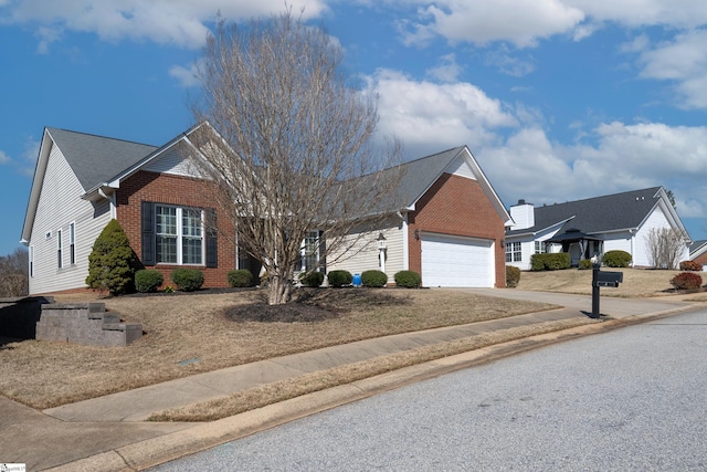 view of front of property with a garage, concrete driveway, and brick siding