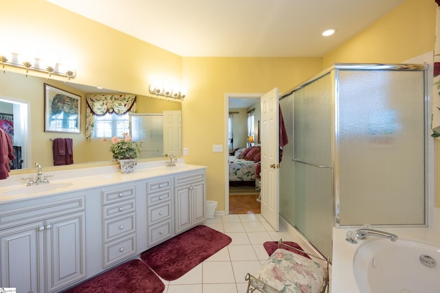 ensuite bathroom featuring a stall shower, tile patterned flooring, a sink, and connected bathroom