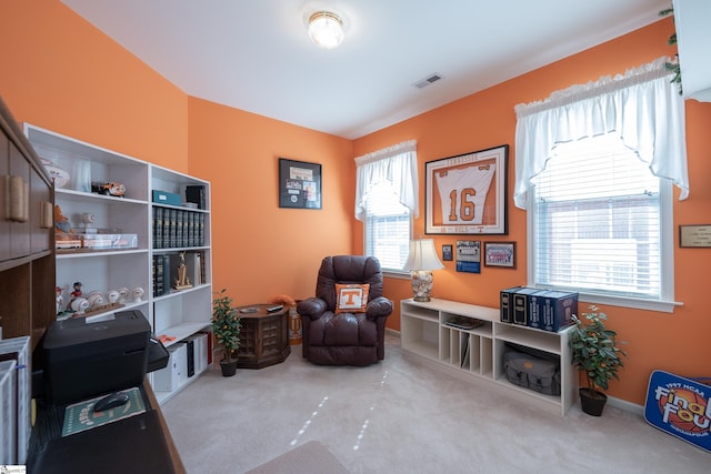 living area with carpet, visible vents, and plenty of natural light