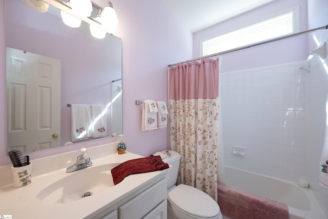 bathroom with vanity, toilet, and shower / bath combo with shower curtain