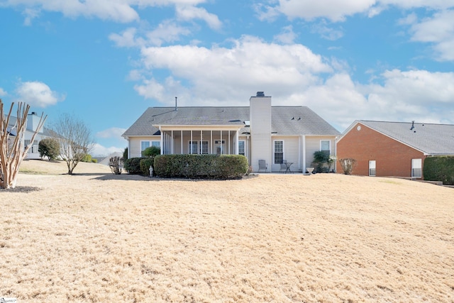 rear view of property featuring a chimney