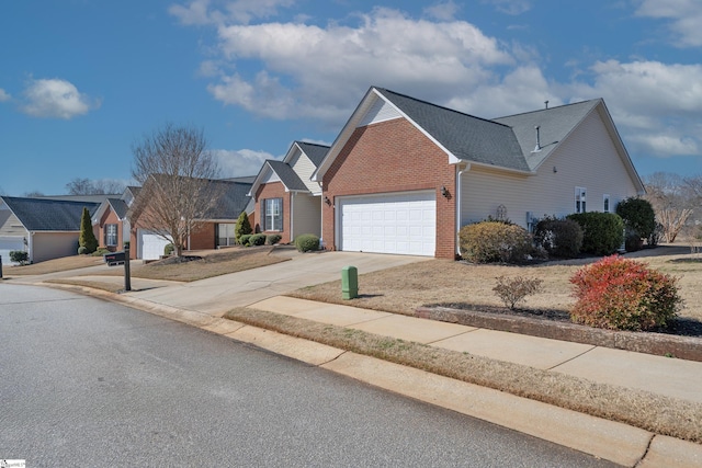 view of front of house featuring driveway, a garage, and brick siding