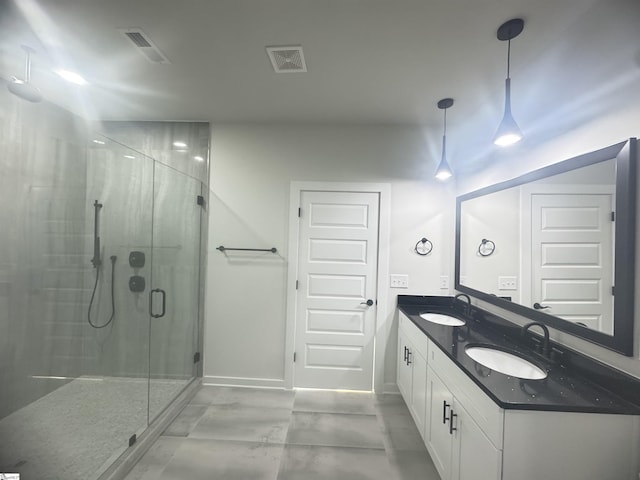 bathroom featuring a sink, visible vents, and a shower stall