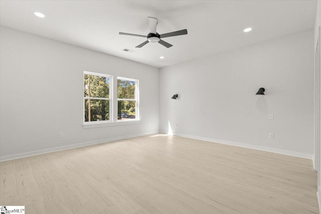 empty room featuring light wood-style floors, recessed lighting, and baseboards