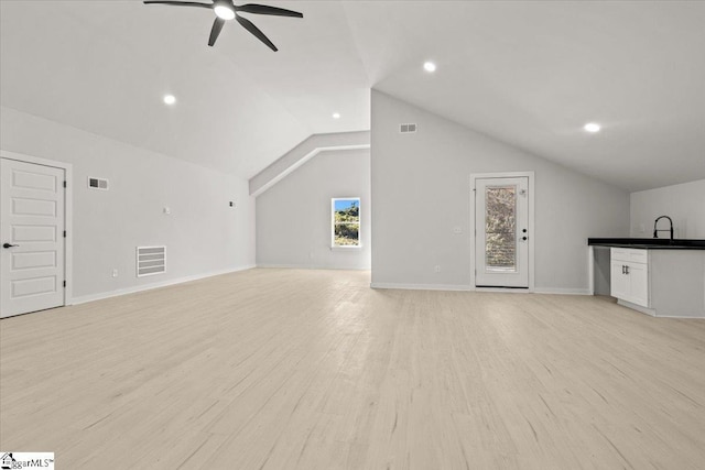 additional living space with ceiling fan, lofted ceiling, visible vents, and light wood-style floors