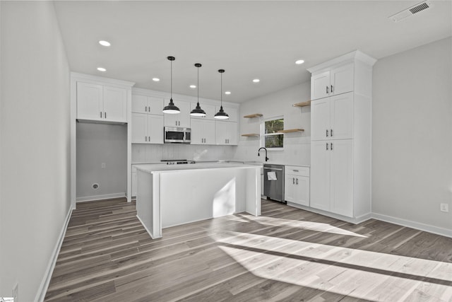 kitchen with stainless steel appliances, visible vents, white cabinets, light wood-type flooring, and open shelves