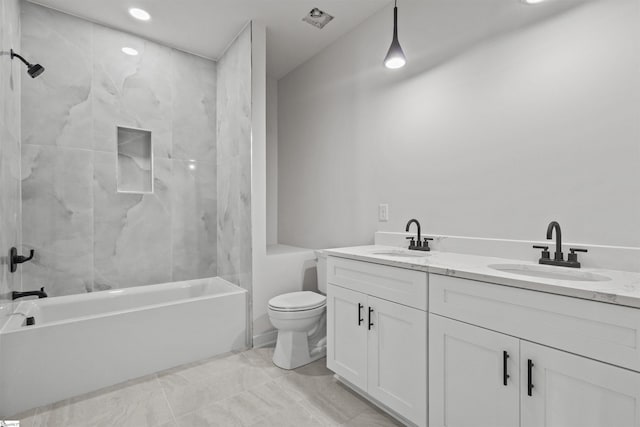 bathroom featuring shower / bathtub combination, double vanity, a sink, and toilet