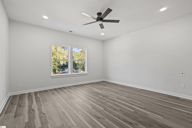 empty room featuring recessed lighting, visible vents, baseboards, and wood finished floors