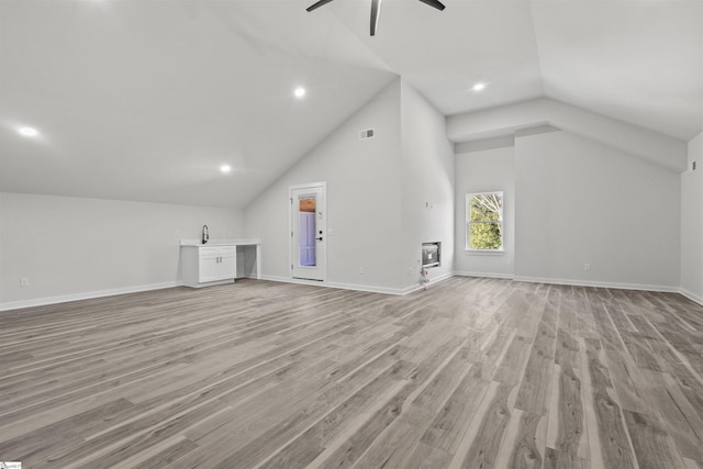 bonus room with light wood-type flooring, ceiling fan, and baseboards