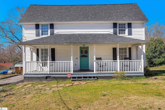 view of front of house with a porch, a front yard, and a shingled roof