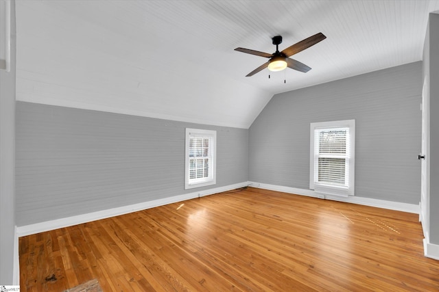 additional living space featuring lofted ceiling, plenty of natural light, and light wood-style flooring