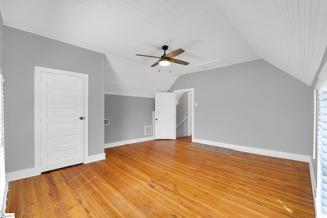 additional living space with lofted ceiling, ceiling fan, visible vents, baseboards, and light wood-style floors