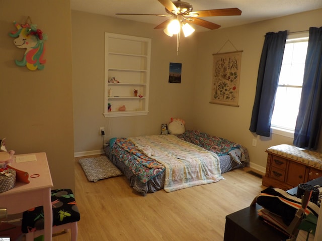 bedroom featuring baseboards, ceiling fan, visible vents, and light wood finished floors