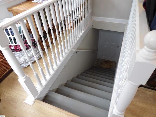 staircase featuring wood finished floors