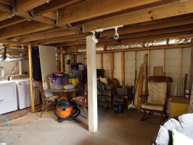 unfinished below grade area featuring concrete block wall and independent washer and dryer