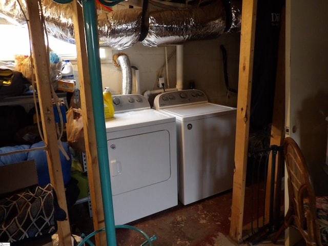 laundry area featuring laundry area, independent washer and dryer, and concrete block wall