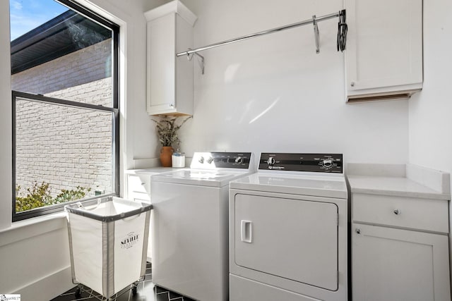 laundry room with independent washer and dryer and cabinet space