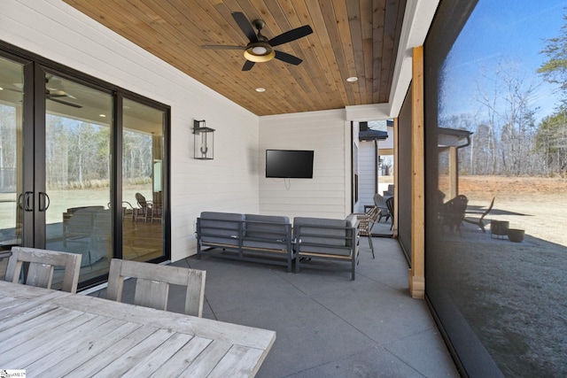 view of patio / terrace with a ceiling fan, french doors, and an outdoor living space