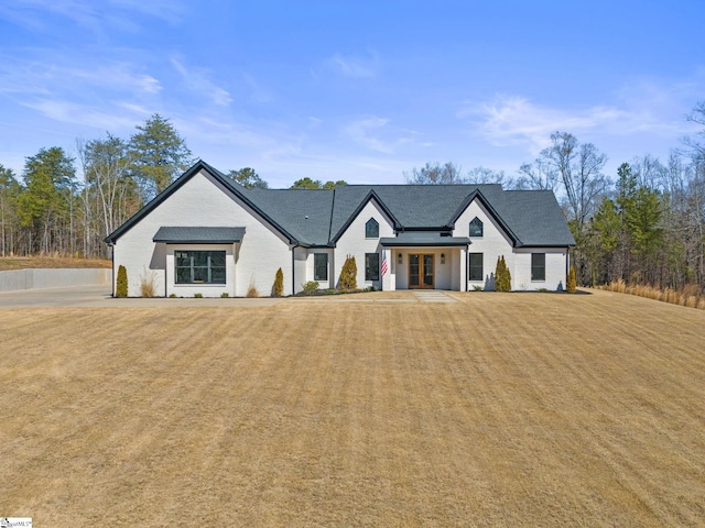 modern farmhouse style home with a front lawn