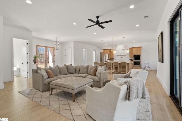 living room featuring french doors, recessed lighting, visible vents, light wood-style floors, and baseboards