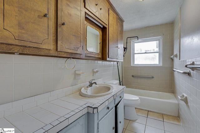 full bath with toilet, tile walls, a textured ceiling, and tile patterned floors