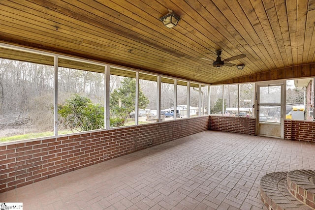 unfurnished sunroom with ceiling fan, lofted ceiling, and wood ceiling