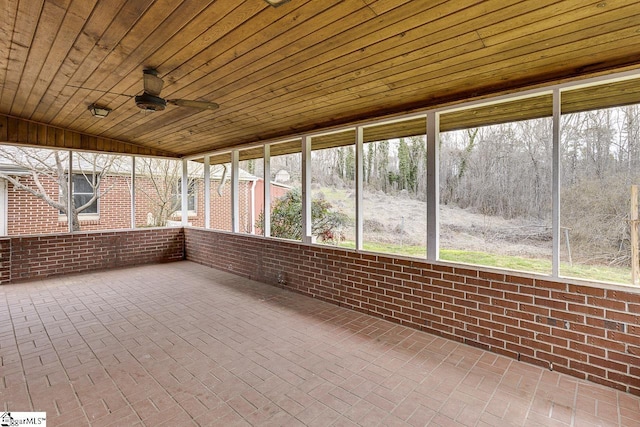 unfurnished sunroom with lofted ceiling, wooden ceiling, and ceiling fan