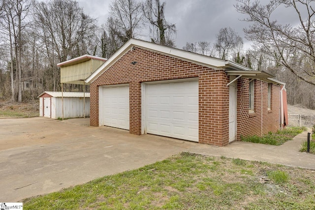 garage with concrete driveway