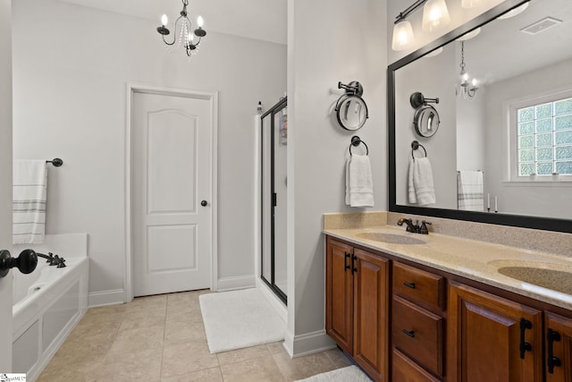 full bathroom with a notable chandelier, a sink, a shower stall, and tile patterned floors