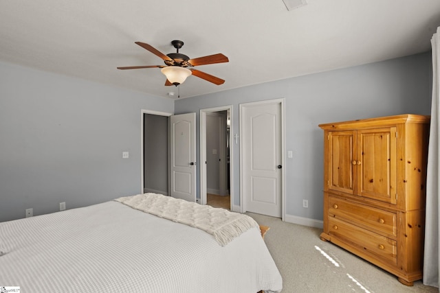 bedroom featuring baseboards, a ceiling fan, and light colored carpet