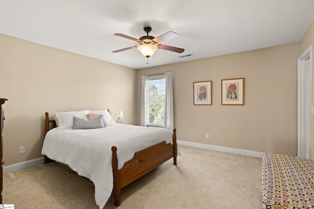 bedroom featuring a ceiling fan, light colored carpet, visible vents, and baseboards