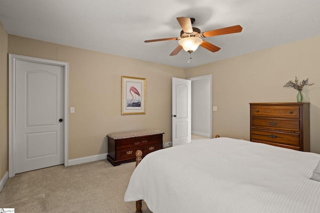 bedroom featuring light carpet, ceiling fan, and baseboards