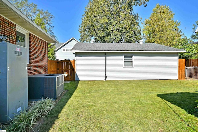 view of yard featuring central AC and fence