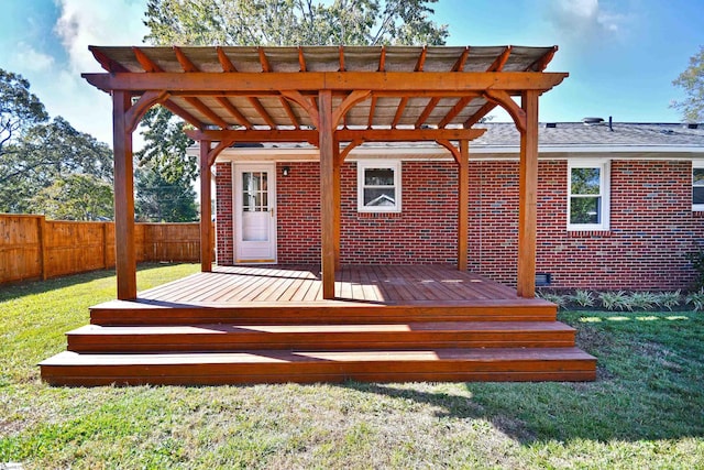 deck with fence, a lawn, and a pergola