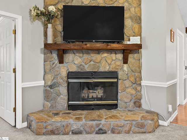 interior details with carpet floors, a fireplace, and baseboards