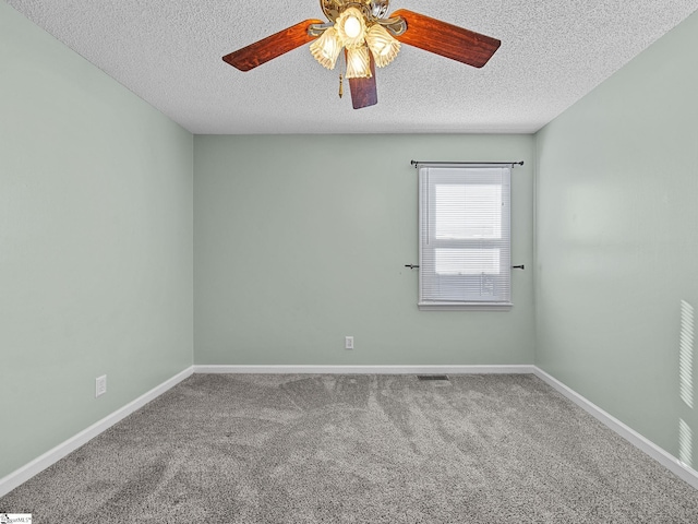 unfurnished room featuring carpet, visible vents, baseboards, and a textured ceiling