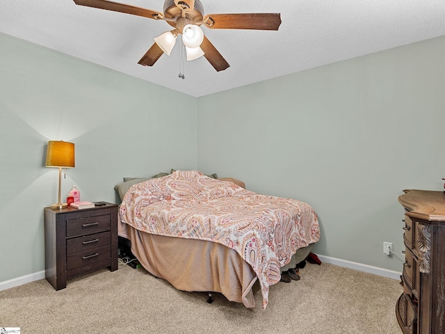 bedroom with light carpet, baseboards, and a ceiling fan