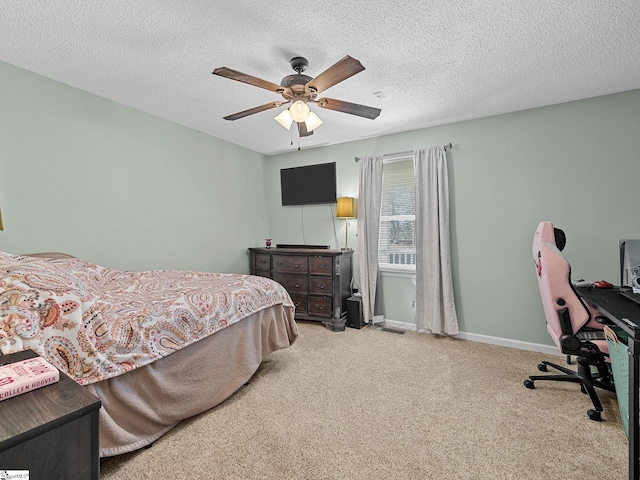 bedroom featuring a ceiling fan, carpet, baseboards, and a textured ceiling