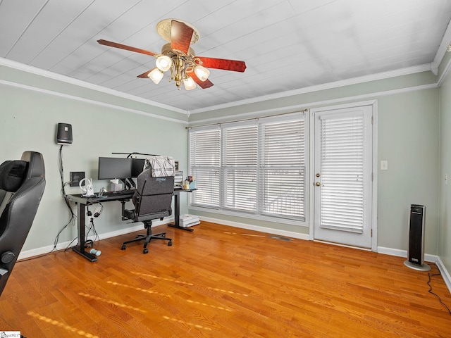 home office featuring visible vents, baseboards, a ceiling fan, wood finished floors, and crown molding