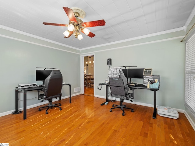 office space featuring crown molding, baseboards, and wood finished floors