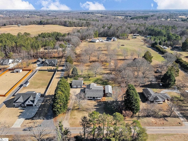 birds eye view of property featuring a wooded view