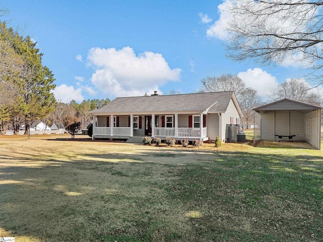 view of front of home featuring covered porch, a front yard, cooling unit, and a detached carport