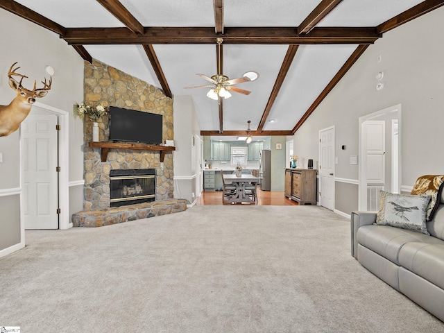 unfurnished living room featuring light carpet, high vaulted ceiling, and a stone fireplace