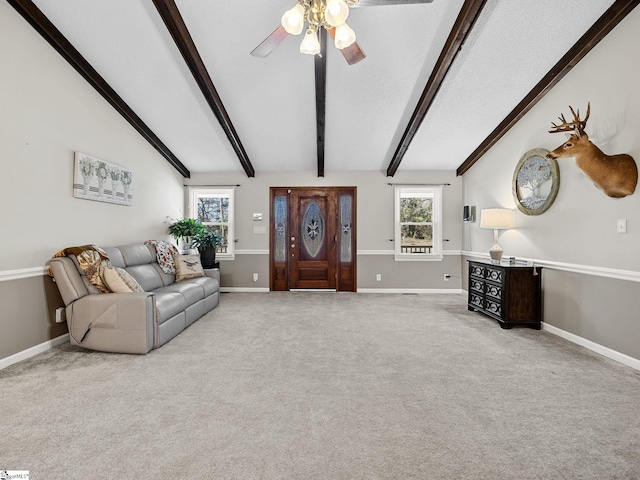 carpeted living room featuring lofted ceiling with beams, ceiling fan, and baseboards