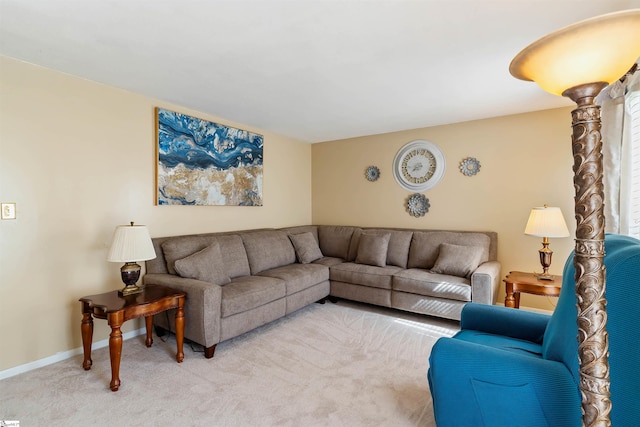 living area featuring baseboards and light colored carpet