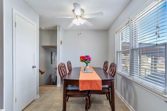 dining room featuring ceiling fan and baseboards