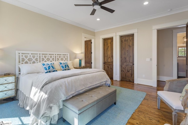 bedroom with crown molding, recessed lighting, ceiling fan, wood finished floors, and baseboards