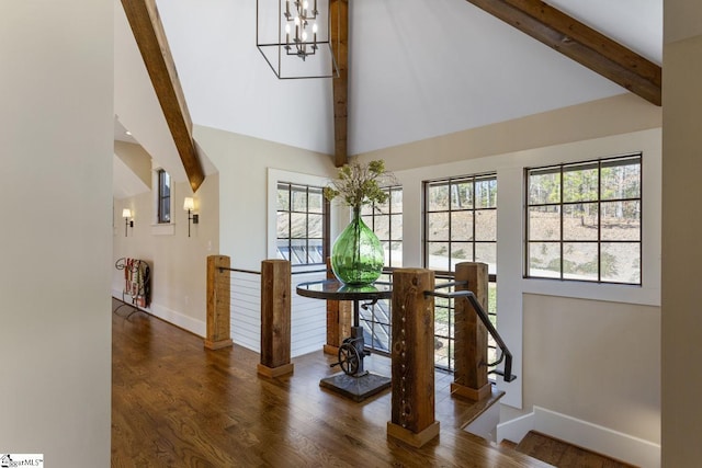 dining room featuring high vaulted ceiling, beamed ceiling, baseboards, and wood finished floors