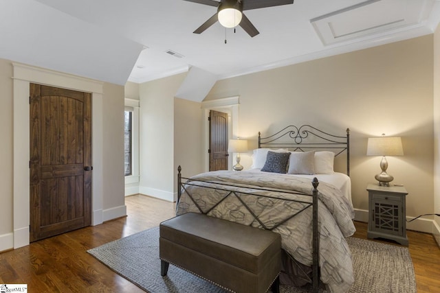 bedroom featuring ceiling fan, visible vents, baseboards, and wood finished floors